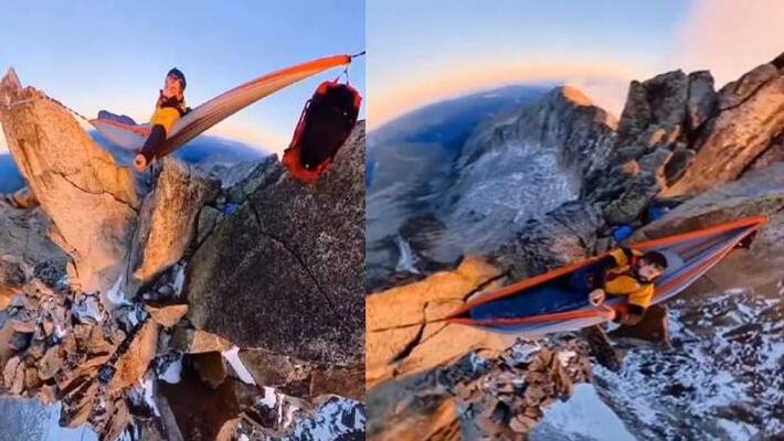 man lying on hammock suspended on high mountain rocks man lying on hammock suspended on high mountain rocks