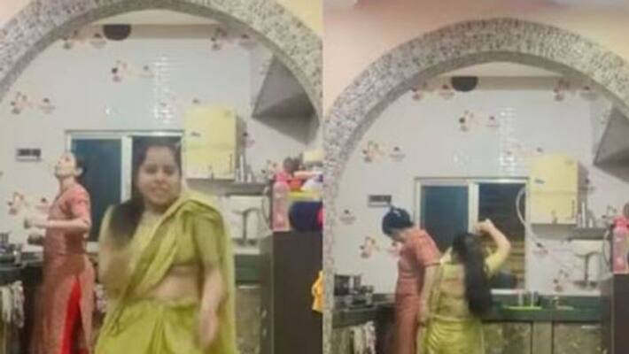 Woman dances enthusiastically in front of her mother in law Woman dances enthusiastically in front of her mother in law
