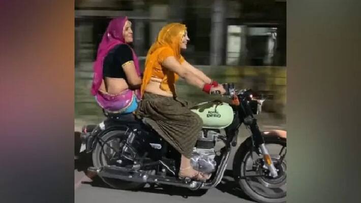 woman riding royal enfield in traditional dress woman riding royal enfield in traditional dress