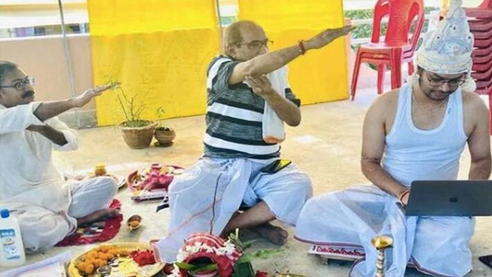 viral photo of groom works on laptop during wedding ceremony viral photo of groom works on laptop during wedding ceremony