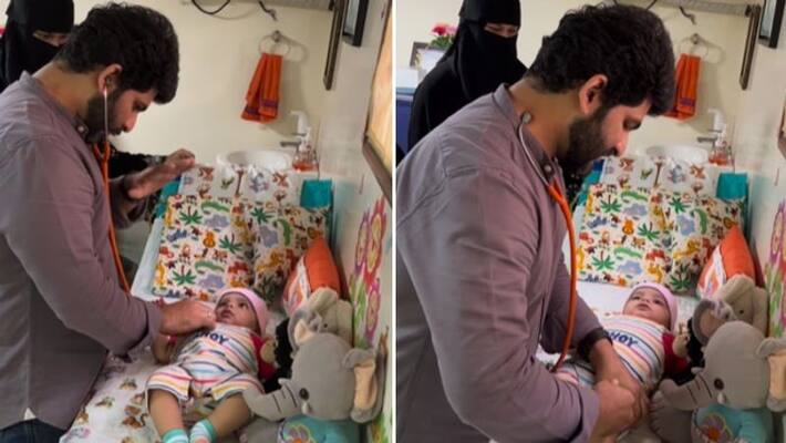 young doctor manages toddler while giving vaccination young doctor manages toddler while giving vaccination