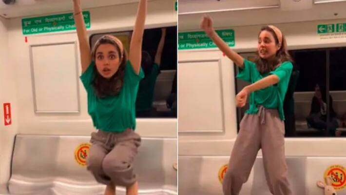 Woman swings on handrails and dances in metro Woman swings on handrails and dances in metro