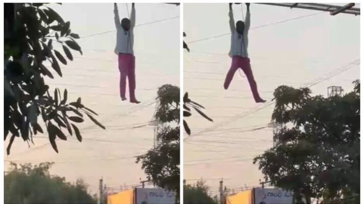 drunk man climbing up billboard in telanganas siddipet, video goes viral drunk man climbing up billboard in telanganas siddipet, video goes viral