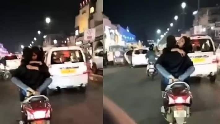Lucknow police searching for couple who do romance on scooty Lucknow police searching for couple who do romance on scooty