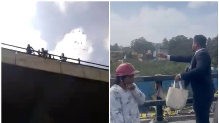 Man rains notes from Bengaluru flyover Man rains notes from Bengaluru flyover