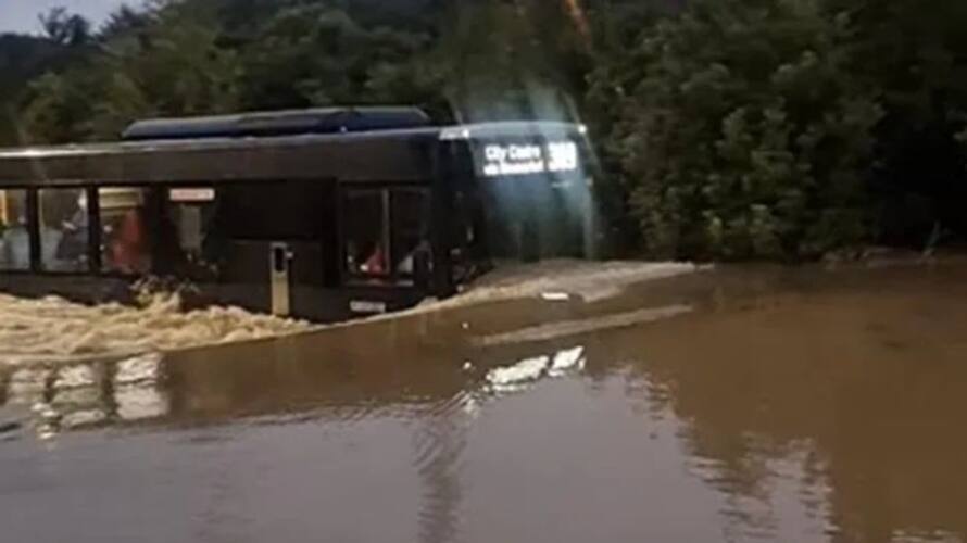 bus moving through flood water bus moving through flood water