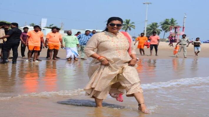 Man holds chappals of minister rk roja in hands Man holds chappals of minister rk roja in hands