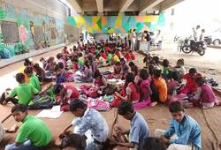 free school under the bridge run by rajesh kumar sharma in delhi yamuna bank dipo ZKAMN
