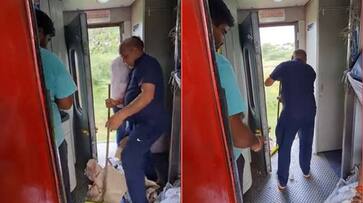 Railway housekeeping staff dumps garbage to outside of train video goes viral ckm Railway housekeeping staff dumps garbage to outside of train video goes viral ckm