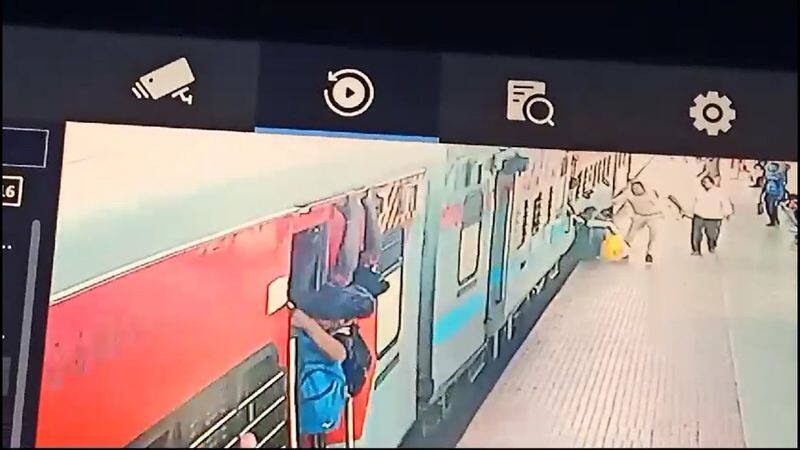 crpf officer rescues a woman passenger who fell down from running train in coimbatore railway station vel