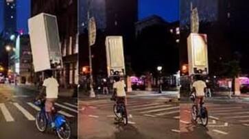 shocking man carrying fridge on head while cycling viral video in tamil mks shocking man carrying fridge on head while cycling viral video in tamil mks