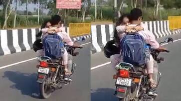 Young Couple in Uttar Pradesh fined Rs 8,000 for hugging while riding a bike; video goes viral-rag Young Couple in Uttar Pradesh fined Rs 8,000 for hugging while riding a bike; video goes viral-rag