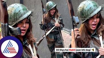 Actress Rakhi Sawant is wearing a soldiers uniform and holding a gun troll suc Actress Rakhi Sawant is wearing a soldiers uniform and holding a gun troll suc