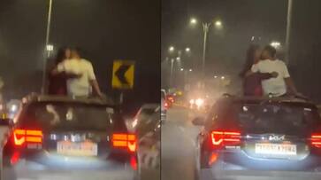 Couple kisses from sunroof of moving car in Hyderabad city Romance video goes viral ckm Couple kisses from sunroof of moving car in Hyderabad city Romance video goes viral ckm