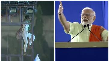 Woman climbed on light tower during the election rally of prime minister Narendra Modi afe Woman climbed on light tower during the election rally of prime minister Narendra Modi afe