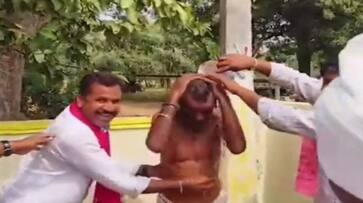 Telangana Polls 2023 BRS workers bathe elderly man in a poll stunt video goes viral ksm Telangana Polls 2023 BRS workers bathe elderly man in a poll stunt video goes viral ksm