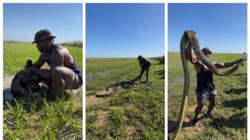 video of a young man catching an anaconda with his bare hands has gone viral bkg video of a young man catching an anaconda with his bare hands has gone viral bkg