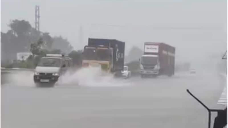 Vehicles move slowly on the Chennai-Bengaluru National Highway due to waterlogged roads vel
