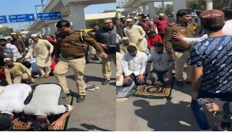 Viral Video Delhi Police Cop was seen hitting and kicking people offering Namaz at road [WATCH] nti