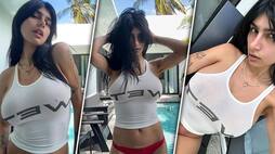 Mia Khalifa SEXY photos: OnlyFans model goes braless in white tanktop and red bikini bottom; check out pics RBA