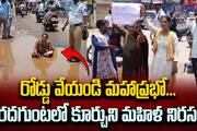 Woman protest for better roads by sitting in pothole in Hyderabad