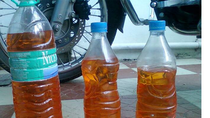 youth pouring orange juice on the name of petrol in hanamkonda - bsb youth pouring orange juice on the name of petrol in hanamkonda - bsb